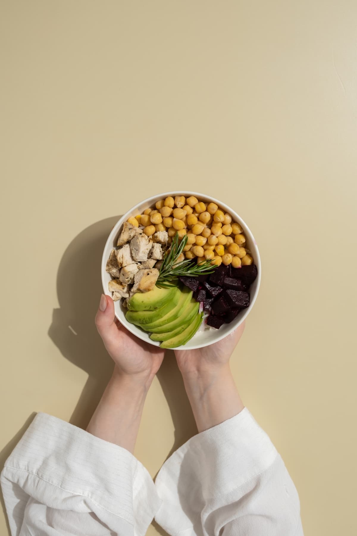 A bowl of chicken, chickpeas, beets and avocado